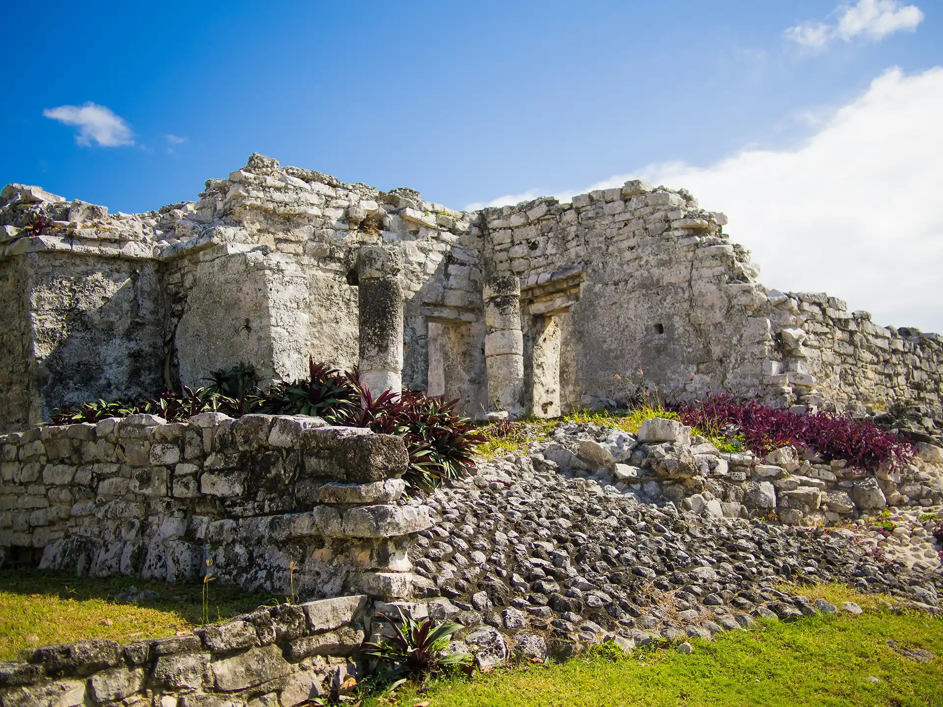 Stone ruins of an ancient Mayan structure at the Tulum archaeological site.